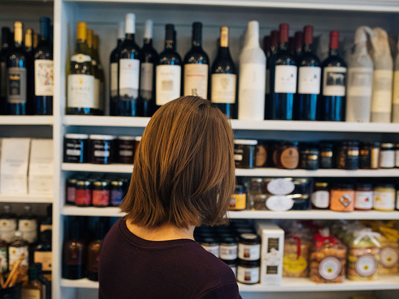 Oakville Grocery customer shopping for wine