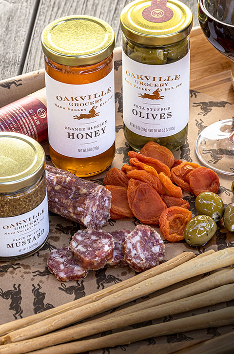 Picture showing Oakville Grocery Preserves, Honey, Olives, and a Charcuterie Board